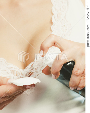 Woman with cotton swab cleaning her skin. 123479180