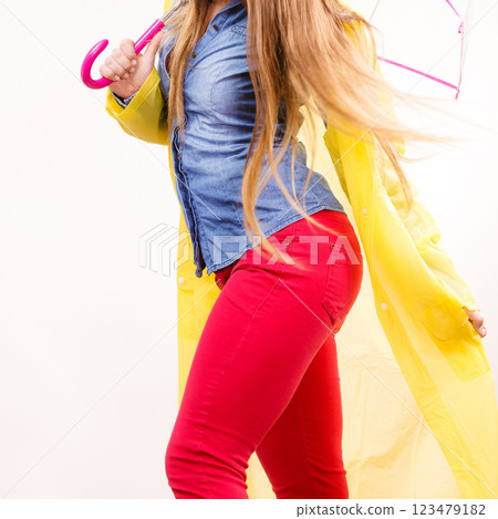 Woman wearing waterproof coat holding umbrella 123479182