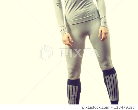 Fit female legs wearing thermoactive underwear 123479185