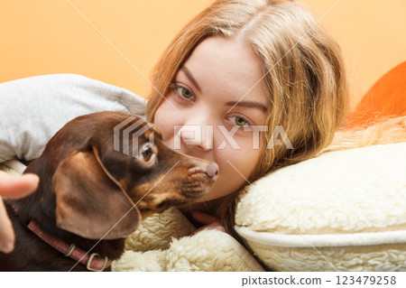 Woman with dog waking up in bed after sleeping. Woman with dog waking up in bed after sleeping. 123479258