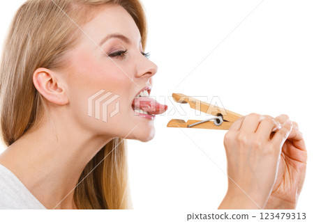 Blonde woman having tongue in clothespin 123479313