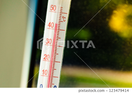 Thermometer shows high temperature during heat waves outside. Thermometer shows high temperature during heat waves outside. 123479414
