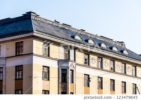 Elegant architectural detail of a Helsinki residential building, showcasing its metal roof and dormer windows. Elegant architectural detail of a Helsinki residential building, showcasing its metal roof and dormer windows. 123479645