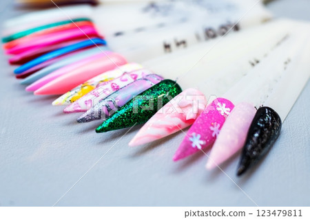 A collection of various colored nails is resting on a table surface 123479811