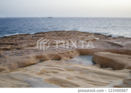 Rocky shore of Fond Ghadir beach in Sliema, Malta close up Rocky shore of Fond Ghadir beach in Sliema, Malta close up 123480867