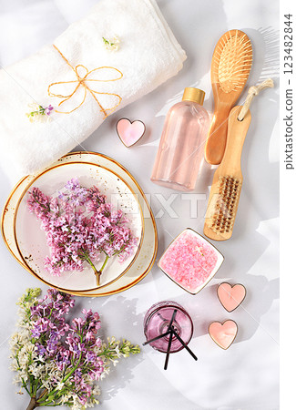 Spa and wellness composition with aromatic rose water, lilac water and lilac flowers, aromatherapy and skin care, lifestyle and organic cosmetics concept, salon invitation and advertisement, selective Spa and wellness composition with aromatic rose water, lilac water and lilac flowers, aromatherapy and skin care, lifestyle and organic cosmetics concept, salon invitation and advertisement, selective 123482844