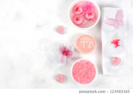 Spa and wellness composition with aromatic rose water, salt, roses, archidea flowers and sakura, towels, aromatherapy and skincare, lifestyle concept, invitation and advertising, selective focus 123483165