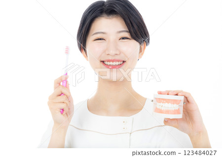 Dental hygienist with toothbrush Dental hygienist with toothbrush 123484027