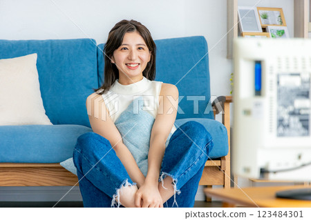 Woman relaxing in her room watching TV 123484301