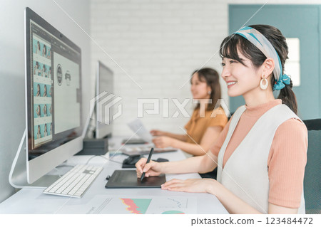 A woman who works as a photo editor, image editor, photo processor, retoucher, and graphic designer A woman who works as a photo editor, image editor, photo processor, retoucher, and graphic designer 123484472