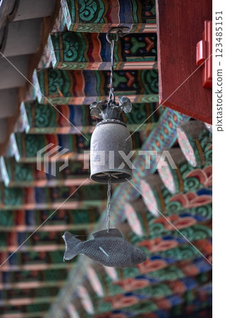 Punggyeong, a wind chime in fish shape. It is often placed near entryways in Korean buildings for protection and as a reminder of Buddhist teachings 123485151