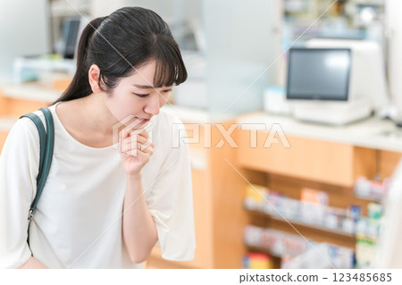 A woman shopping at a pharmacy, drug store, or convenience store 123485685