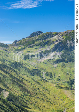 Mount Jodo and Mount Ryuo seen from the Raichozawa hiking trail. Climbing Mount Tsurugi in the Northern Alps 123486571