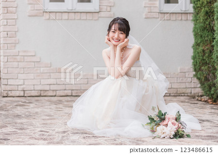 A bride and groom taking wedding photos in the garden of a wedding venue A bride and groom taking wedding photos in the garden of a wedding venue 123486615