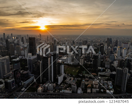 Sunset over Bangkok with skyscrapers and highway visible, warm sky colors blending with the urban skyline. Bangkok, Thailand. Sunset over Bangkok with skyscrapers and highway visible, warm sky colors blending with the urban skyline. Bangkok, Thailand. 123487045