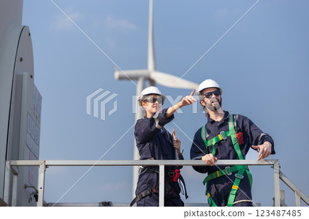 Team engineer wind turbine worker safety uniform survey discuss operational planning windmill field clean energy. Alternative technology protect environment reduce global warming problems. Team engineer wind turbine worker safety uniform survey discuss operational planning windmill field clean energy. Alternative technology protect environment reduce global warming problems. 123487485