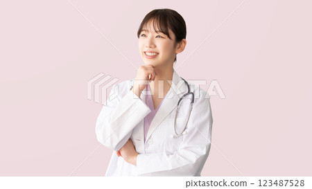 Smiling female medical staff in white coat Smiling female medical staff in white coat 123487528