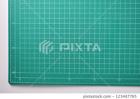 green cutting mat board on white background with line and scale measure guide pattern for art design green cutting mat board on white background with line and scale measure guide pattern for art design 123487765