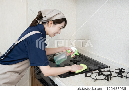 House cleaning woman cleaning the gas stove 123488086
