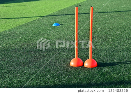 artificial green grass soccer field with orange training cones artificial green grass soccer field with orange training cones 123488236
