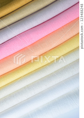 stack of colourful cotton clothes, pile of clothing on white background 123488248