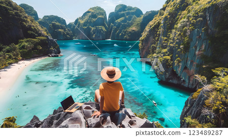 serene tropical landscape with a woman enjoying the view of turquoise waters and green cliffs 123489287