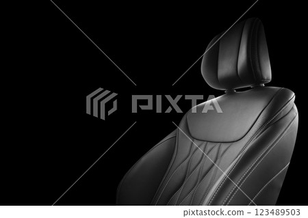 Black leather interior of the luxury modern car. Perforated black leather. Seats with stitching isolated on black background. Modern car interior details. Car inside Black leather interior of the luxury modern car. Perforated black leather. Seats with stitching isolated on black background. Modern car interior details. Car inside 123489503