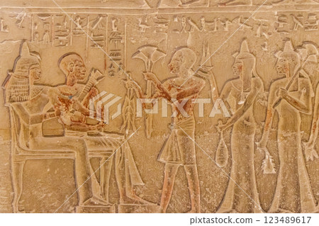 Ancient egyptian paintings and hieroglyphs carved on the stone wall Ancient egyptian paintings and hieroglyphs carved on the stone wall 123489617