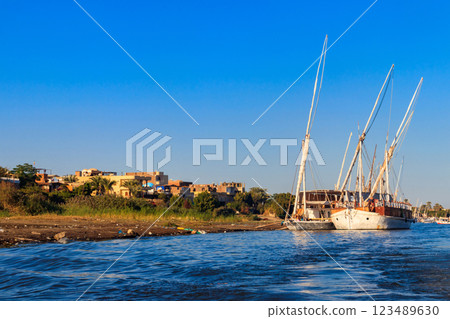 Felucca boats moored near the shore of Nile river in Luxor, Egypt Felucca boats moored near the shore of Nile river in Luxor, Egypt 123489630