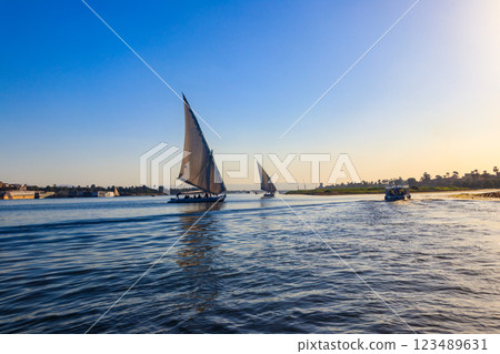 Felucca boats sailing on the Nile river in Luxor, Egypt. Traditional Egyptian sailing boats Felucca boats sailing on the Nile river in Luxor, Egypt. Traditional Egyptian sailing boats 123489631