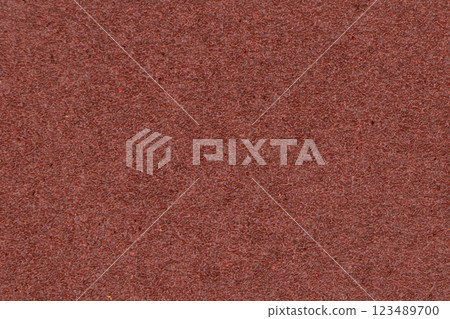 The structure of the sandpaper surface. Sandpaper texture background with pattern of red sand grains. Abrasive material texture 123489700