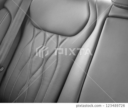 Back passenger black seats in modern luxury car. Black perforated leather with white stitching. Car details. Leather comfortable seats. Car interior details Back passenger black seats in modern luxury car. Black perforated leather with white stitching. Car details. Leather comfortable seats. Car interior details 123489726