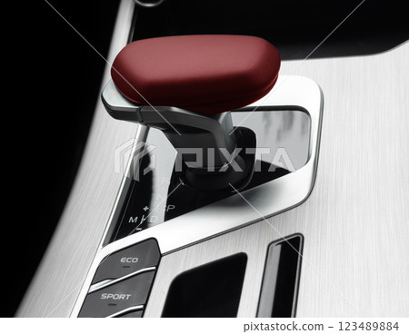 Automatic gear stick of a modern car. Modern car interior details. Close up view. Car inside. Automatic transmission lever shift. Black leather interior with stitching Automatic gear stick of a modern car. Modern car interior details. Close up view. Car inside. Automatic transmission lever shift. Black leather interior with stitching 123489884
