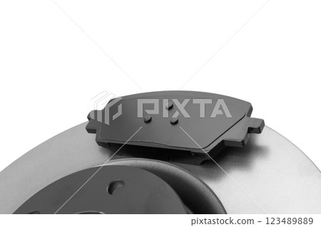 Brake discs and brake pads isolated on white background. Auto parts. Brake disc rotor isolated on white. Braking disk. Car part. Quality spare parts for car service or maintenance Brake discs and brake pads isolated on white background. Auto parts. Brake disc rotor isolated on white. Braking disk. Car part. Quality spare parts for car service or maintenance 123489889