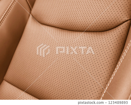 Brown luxury modern car Interior. Detail of modern car interior. Part of brown leather seats with stitching in expensive car Brown luxury modern car Interior. Detail of modern car interior. Part of brown leather seats with stitching in expensive car 123489893