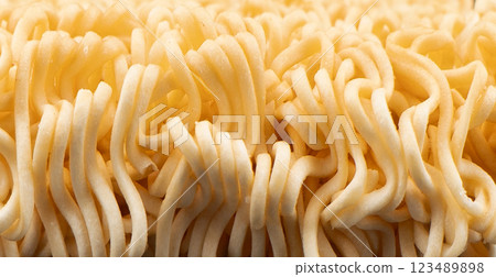 Texture of dry instant noodles  background. Raw dried Instant ramen noodles block 123489898
