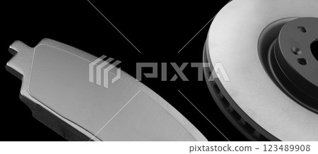 Brake discs and brake pads isolated on black background. Auto parts. Brake disc rotor isolated. Braking disk. Car part. Quality spare parts for car service or maintenance 123489908