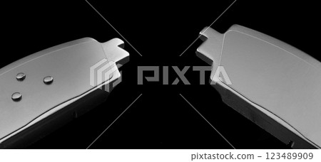 Brake pads isolated on black background. Auto parts. Brake pads isolated on black. Braking pads. Car part. Car detailing. Spare parts 123489909