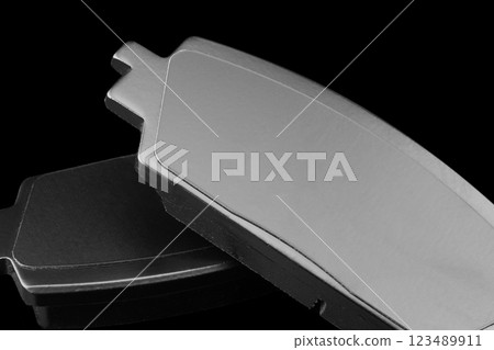 Brake pads isolated on black background. Auto parts. Brake pads isolated on black. Braking pads. Car part. Car detailing. Spare parts 123489911