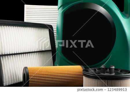 Car engine oil and filters isolated on black background. Car oil, air, fuel filters and motor oil in plastic can isolated. Quality spare parts for car service or maintenance Car engine oil and filters isolated on black background. Car oil, air, fuel filters and motor oil in plastic can isolated. Quality spare parts for car service or maintenance 123489913