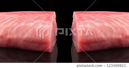Yellow fin tuna steak isolated on black background. Fresh rare tuna steak isolated. Raw yellowfin tuna fillet texture. Background fresh fish meat. Top view of slices of tuna meat. Yellow fin tuna steak isolated on black background. Fresh rare tuna steak isolated. Raw yellowfin tuna fillet texture. Background fresh fish meat. Top view of slices of tuna meat. 123489921