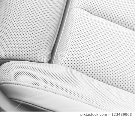 White leather interior of the luxury modern car. Perforated white leather comfortable seats with stitching. Modern car interior details. 123489968