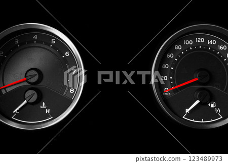 Close up shot of a speedometer in a car. Car dashboard. Dashboard details with indication lamps.Car instrument panel. Dashboard with speedometer, tachometer, odometer. 123489973