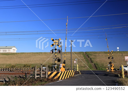 Tobu Nikko Line railroad crossing hacked into the Tone River super levee 123490552