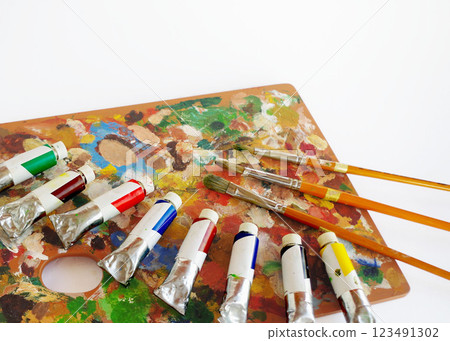 Oil paints, painting supplies, wooden palette, paints, painting materials, paintbrushes Oil paints, painting supplies, wooden palette, paints, painting materials, paintbrushes 123491302