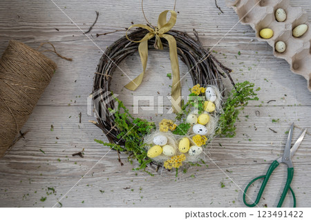 DIY process of woman making candid Easter wreath arrangement decor. Small business, self employed entrepreneur, self-made career. Series of handmade craft instruction. Zero waste eco-friendly 123491422