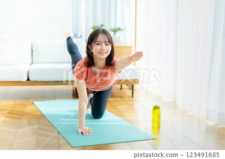 Young woman doing yoga in the living room 123491685