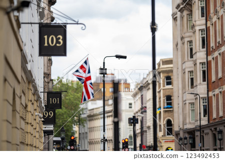 London street captures the essence of British heritage with classic architecture, numbered storefronts, and a Union Jack flag adding a patriotic touch. London street captures the essence of British heritage with classic architecture, numbered storefronts, and a Union Jack flag adding a patriotic touch. 123492453