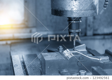 The CNC milling machine cutting mold part by solid ball nose end mill tool in the light blue scene with lighting effect. The CNC milling machine cutting mold part by solid ball nose end mill tool in the light blue scene with lighting effect. 123492561