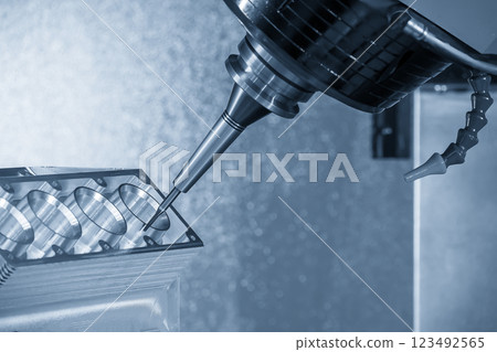 The 5-axis machining center cutting the cylinder block with solid ball nose end mill tool in the light blue scene. 123492565